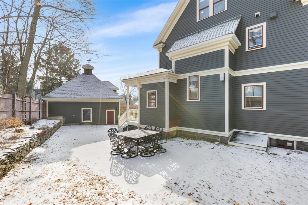 129 High Street Reading, MA 01867 - Photo 32 of 41 a view of a house with a yard covered in snow