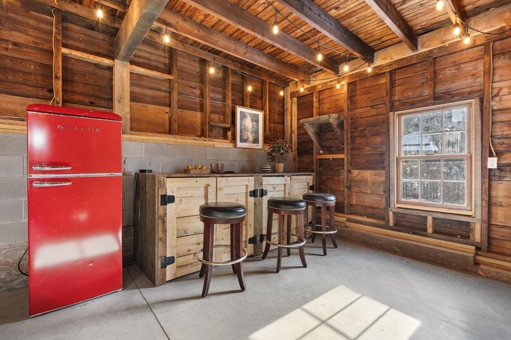 129 High Street Reading, MA 01867 - Photo 38 of 41 a dining room with furniture and a chandelier