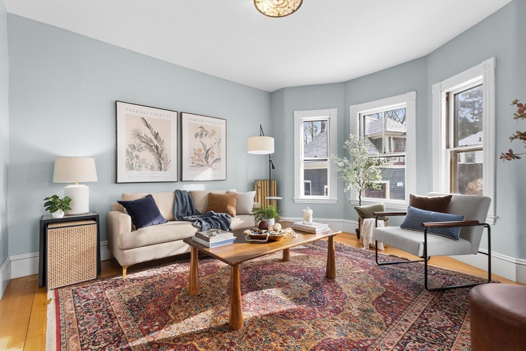 129 High Street Reading, MA 01867 - Photo 6 of 41 a living room with furniture and a potted plant