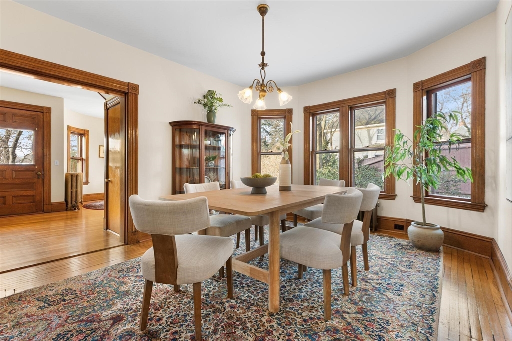 129 High Street Reading, MA 01867 - Photo 9 of 41 a dining room with furniture a chandelier and wooden floor