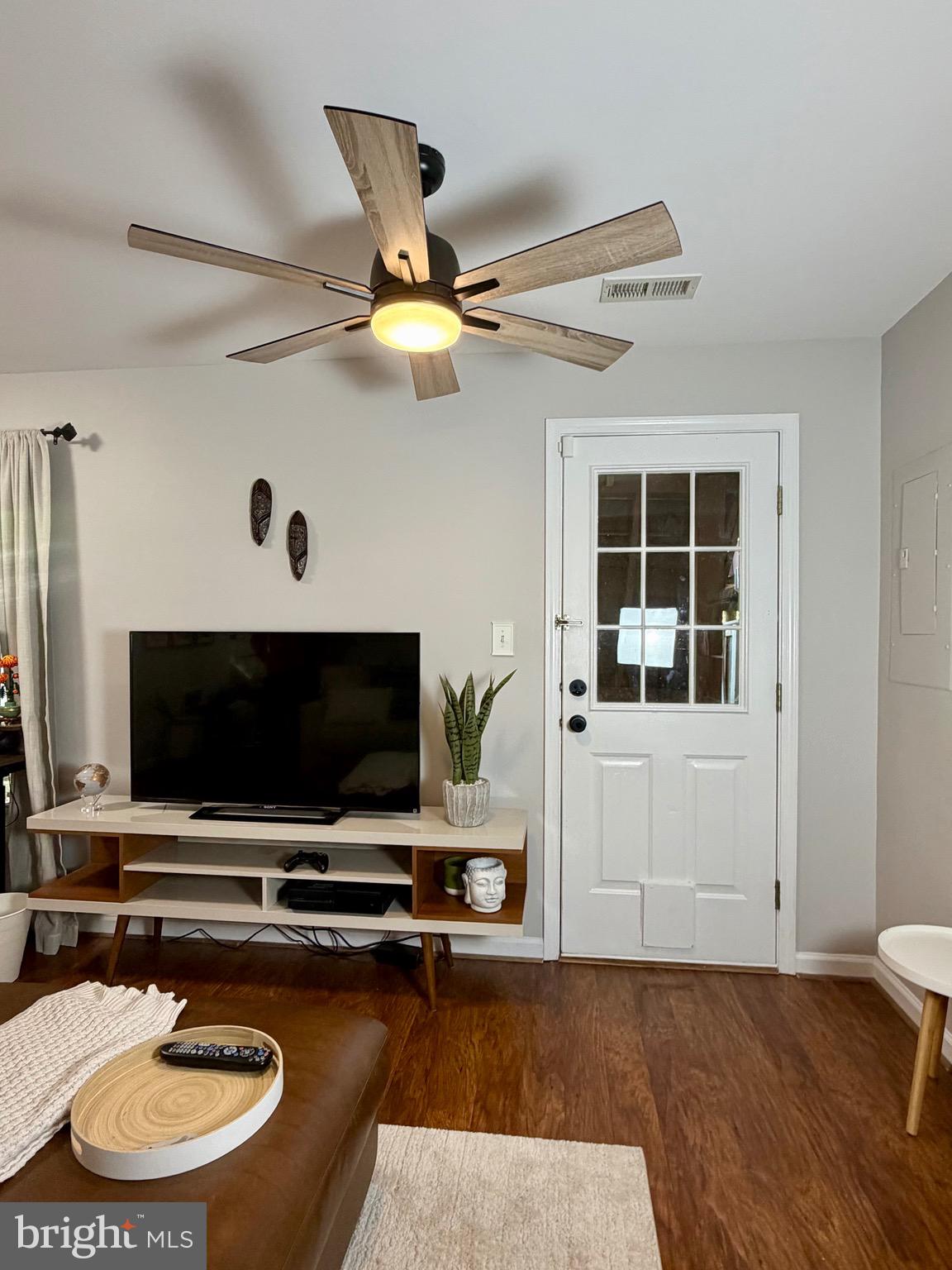 7108 Wheeling Way Gainesville, VA 20155 - Photo 7 of 45 a living room with furniture and a flat screen tv