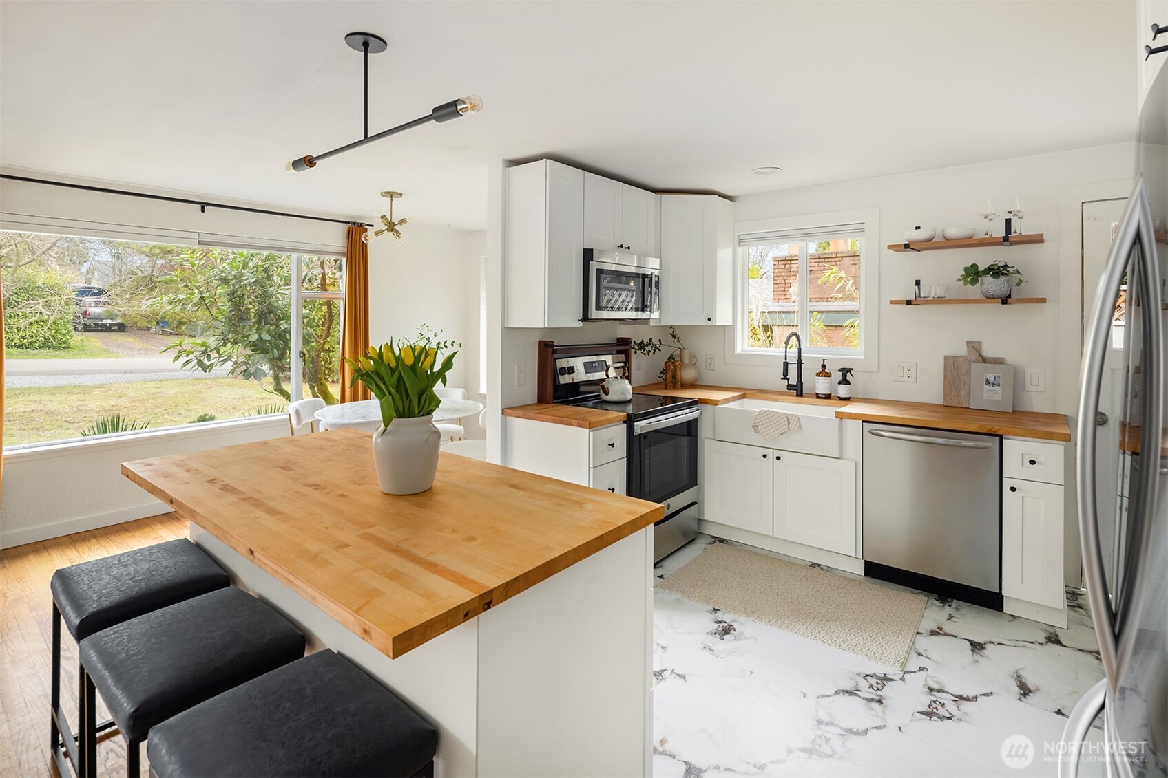 1237 Southwest 118th Street Burien, WA 98146 - Photo 13 of 27 a kitchen with a sink a stove and chairs