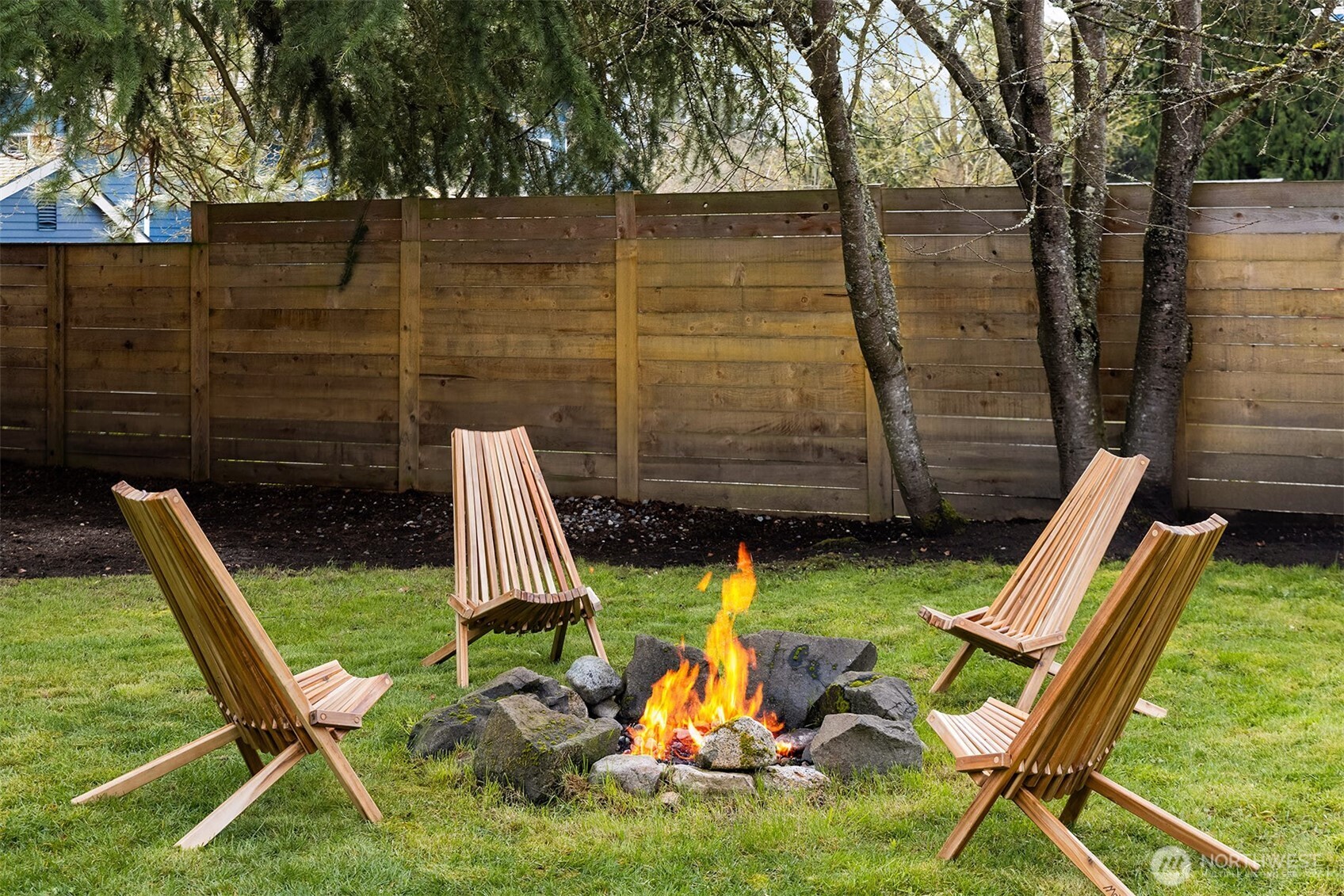1237 Southwest 118th Street Burien, WA 98146 - Photo 24 of 27 a view of a backyard with chairs and a fire pit