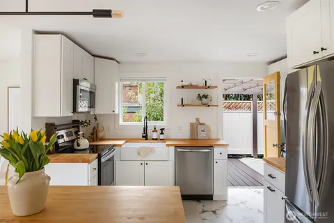 a kitchen with a sink refrigerator and cabinets