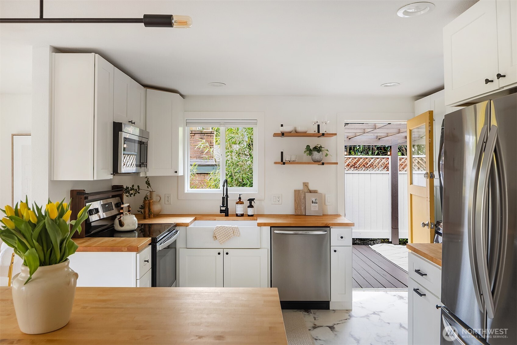 1237 Southwest 118th Street Burien, WA 98146 - Photo 8 of 27 a kitchen with a sink refrigerator and cabinets
