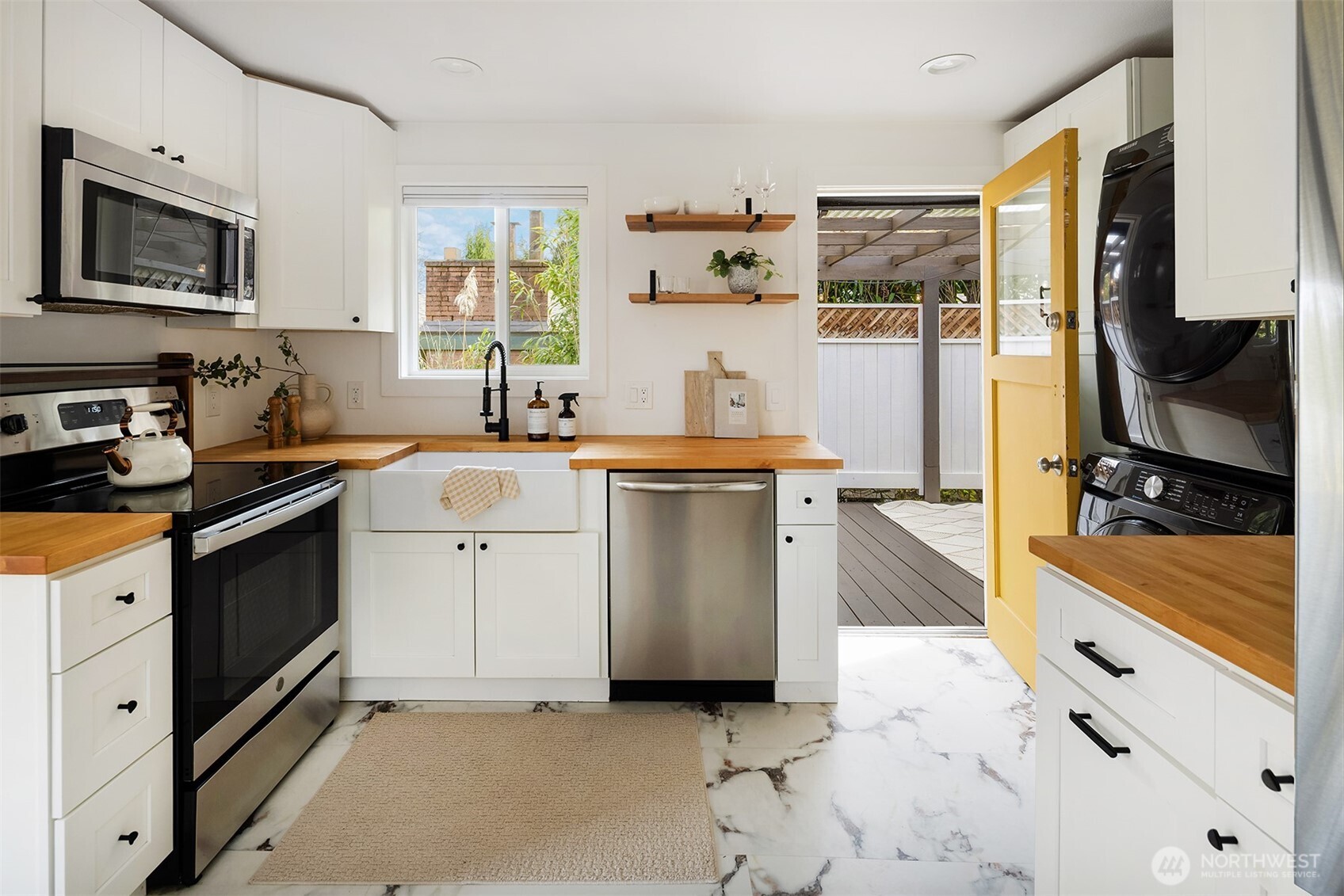1237 Southwest 118th Street Burien, WA 98146 - Photo 9 of 27 a kitchen with stainless steel appliances a stove microwave and sink