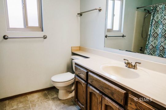 420 Veada Avenue Ridgecrest, CA 93555 - Photo 29 of 41 a bathroom with a sink toilet and a mirror
