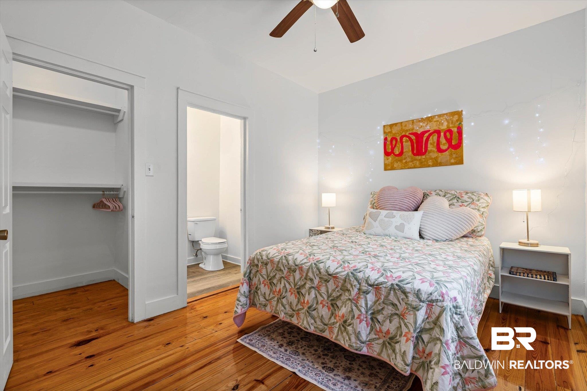 951 Montgomery Street Mobile, AL 36604 - Photo 10 of 22 Bedroom featuring wood-finish flooring, a ceiling fan, and a built-in closet with shelving