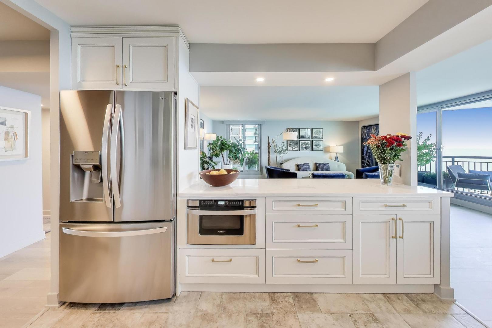 6007 North Sheridan Road, Unit 12B Chicago, IL 60660 - Photo 11 of 38 a kitchen with stainless steel appliances a refrigerator sink and cabinets