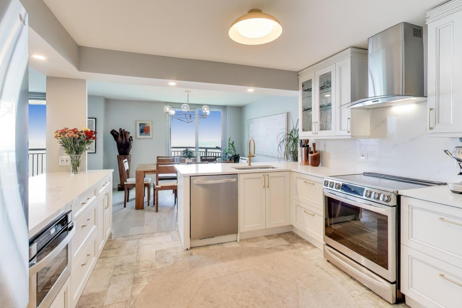 6007 North Sheridan Road, Unit 12B Chicago, IL 60660 - Photo 12 of 38 a kitchen with a sink stove and cabinets