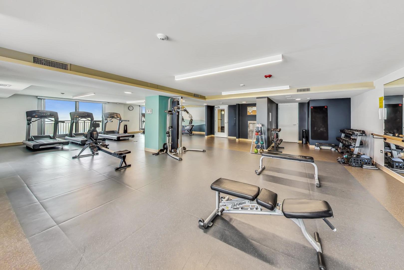 6007 North Sheridan Road, Unit 12B Chicago, IL 60660 - Photo 28 of 38 a room with lots of gym equipment and a view of living room