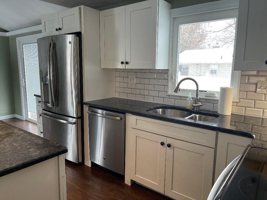 23 Western Avenue West Boylston, MA 01583 - Photo 4 of 18 a kitchen with stainless steel appliances granite countertop a refrigerator sink and white cabinets