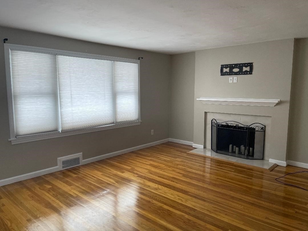 23 Western Avenue West Boylston, MA 01583 - Photo 6 of 18 a view of empty room with window and fireplace