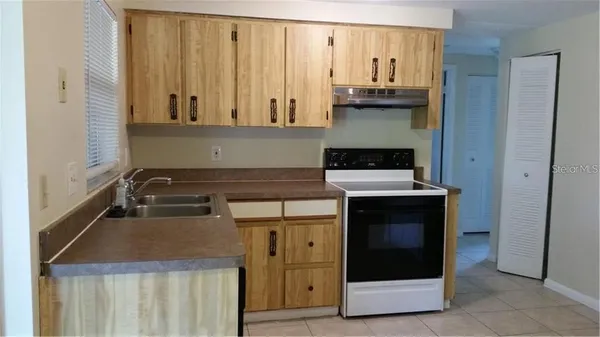 a kitchen with granite countertop a stove and a microwave