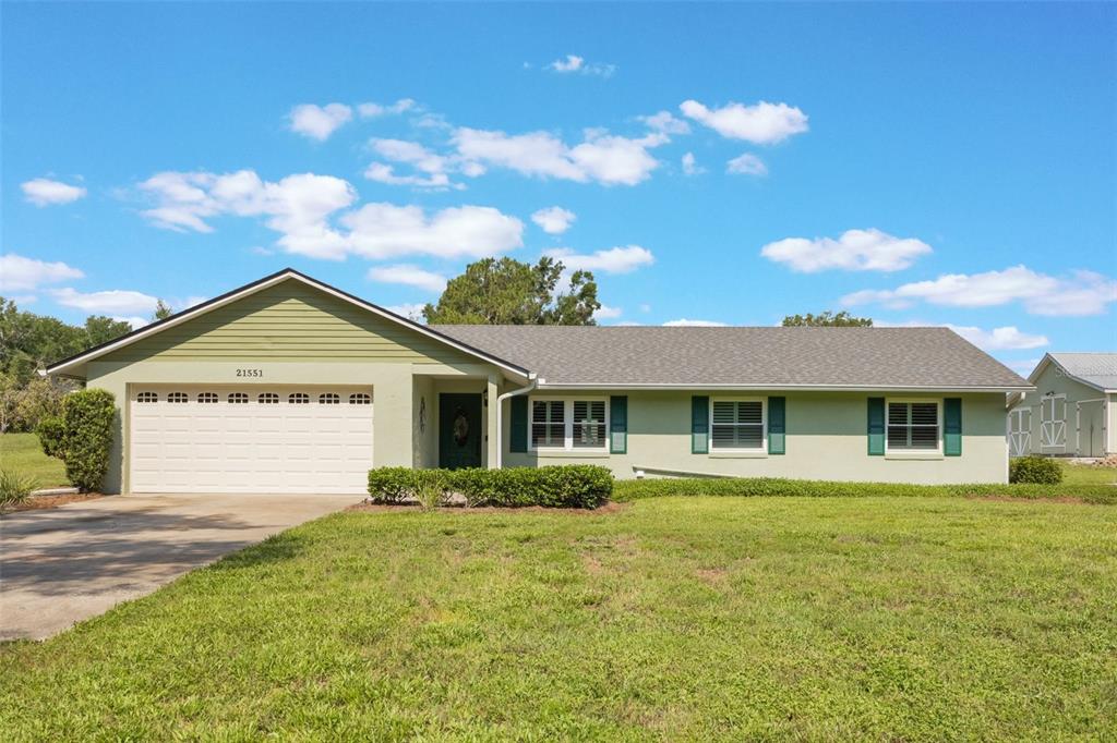 21551 Lake Seneca Road Eustis, FL 32736 - Photo 1 of 1 a view of a house with a yard and potted plants