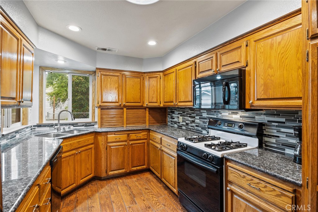 24235 Moon Corning, CA 96021 - Photo 17 of 58 a kitchen with a sink stove top oven and cabinets