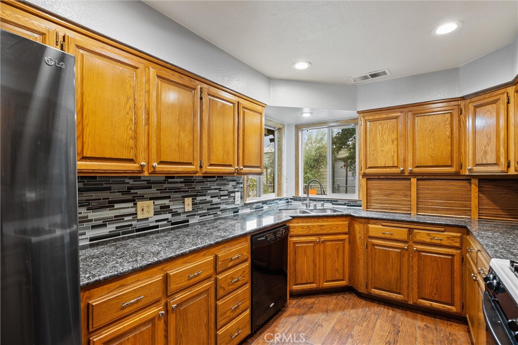 24235 Moon Corning, CA 96021 - Photo 20 of 58 a kitchen with stainless steel appliances a sink and cabinets