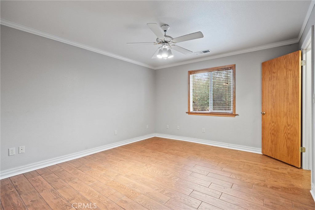 24235 Moon Corning, CA 96021 - Photo 27 of 58 a view of an empty room with chandelier fan and fire place