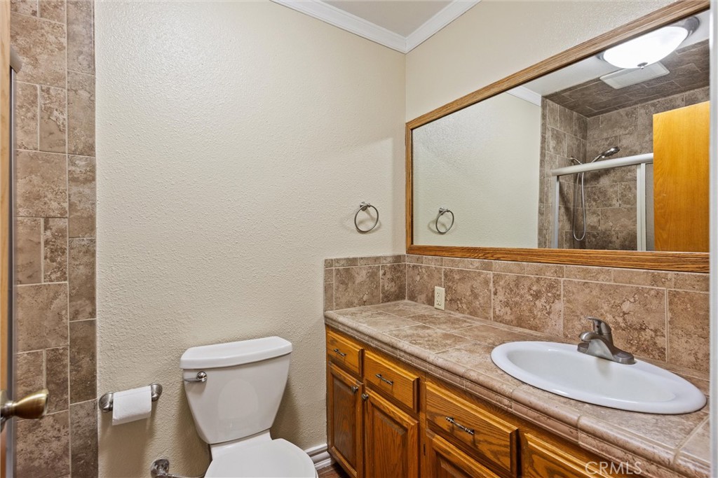 24235 Moon Corning, CA 96021 - Photo 31 of 58 a bathroom with a granite countertop sink and a mirror