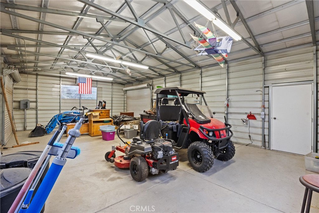 24235 Moon Corning, CA 96021 - Photo 35 of 58 a view of a garage with a bike and wooden roof