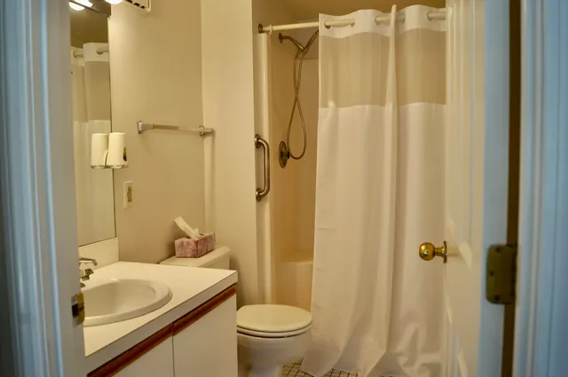 a bathroom with a sink toilet and shower