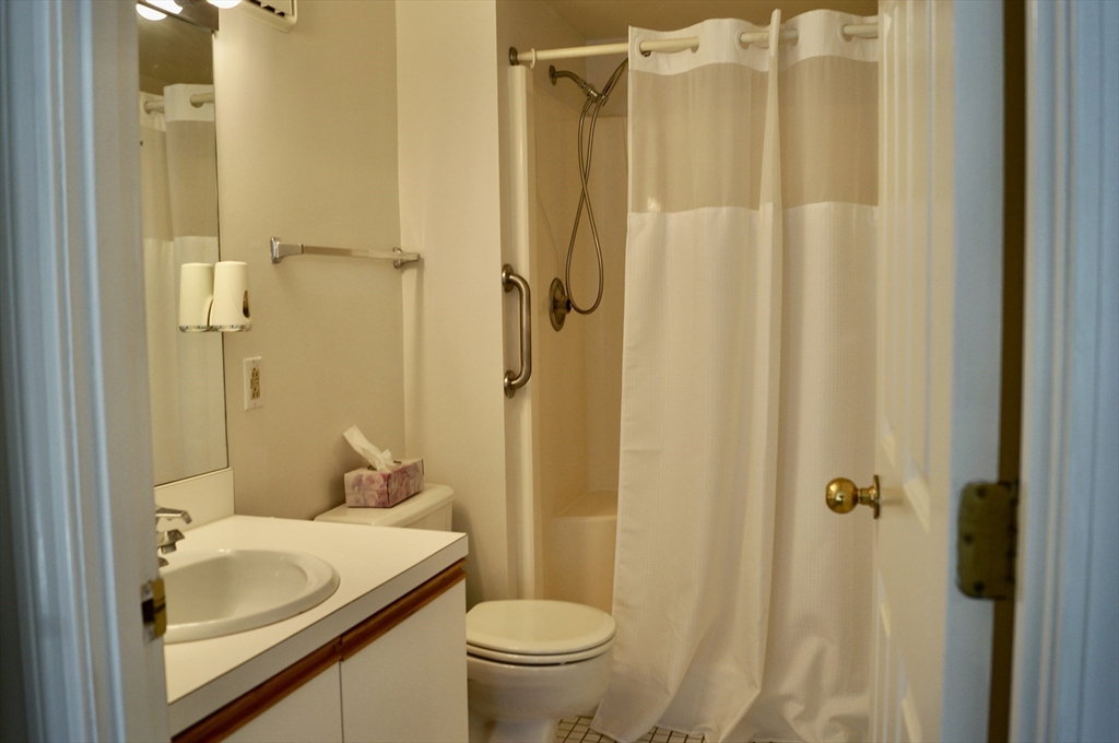 200 Ledgewood Drive, Unit 205 Stoneham, MA 02180 - Photo 14 of 18 a bathroom with a sink toilet and shower