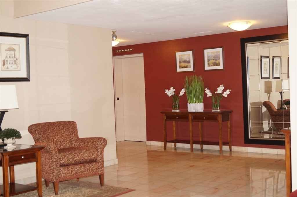 200 Ledgewood Drive, Unit 205 Stoneham, MA 02180 - Photo 2 of 18 a dining room with furniture and chandelier fan