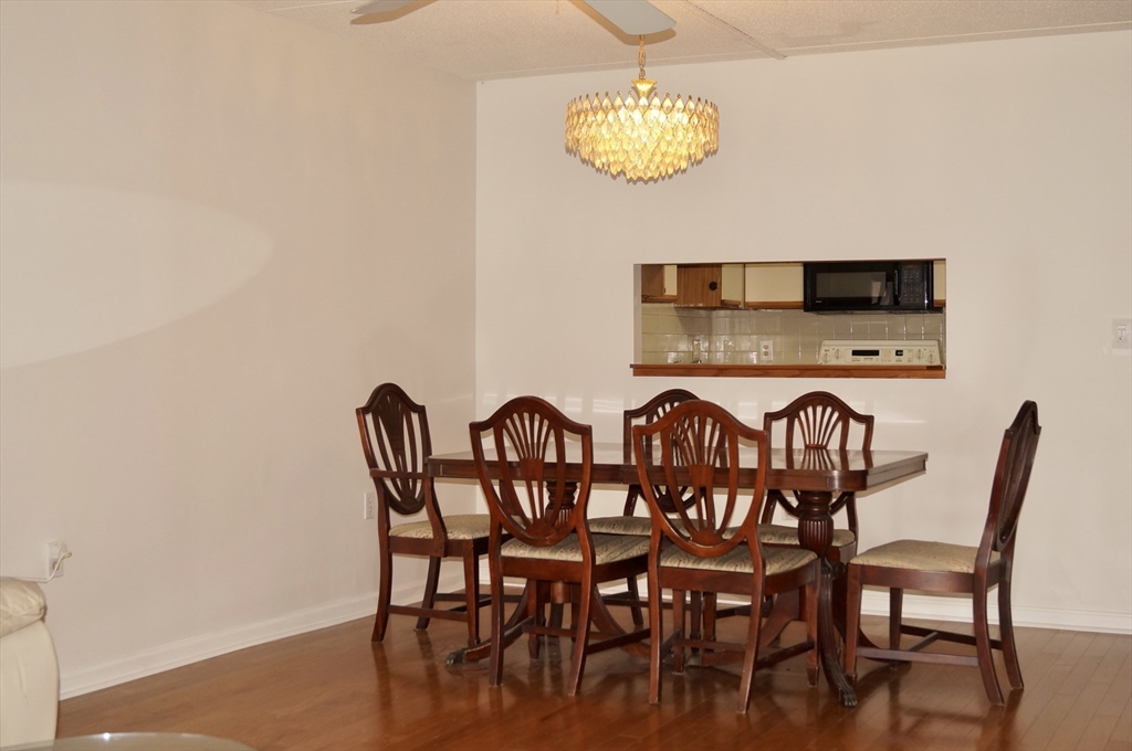 200 Ledgewood Drive, Unit 205 Stoneham, MA 02180 - Photo 7 of 18 a view of a dining room with furniture and chandelier