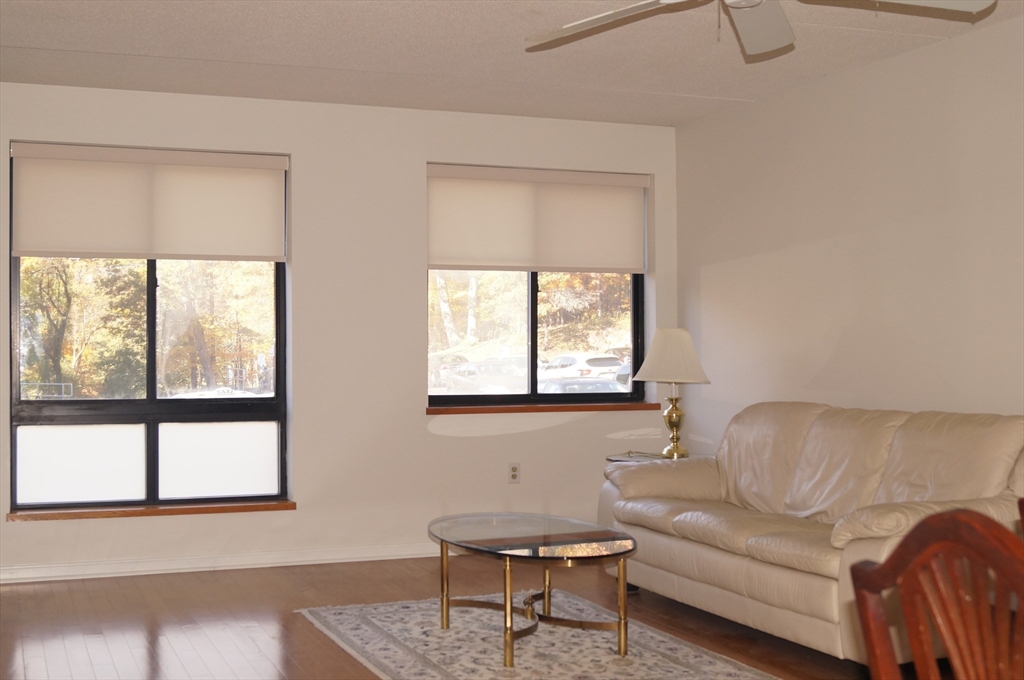 200 Ledgewood Drive, Unit 205 Stoneham, MA 02180 - Photo 9 of 18 a living room with furniture and a window