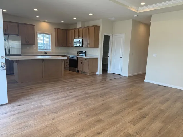 a kitchen with stainless steel appliances granite countertop a refrigerator sink and cabinets