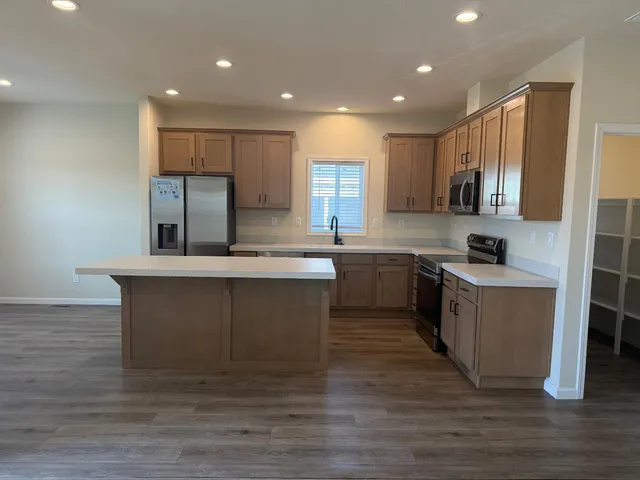 a kitchen with a sink cabinets and wooden floor