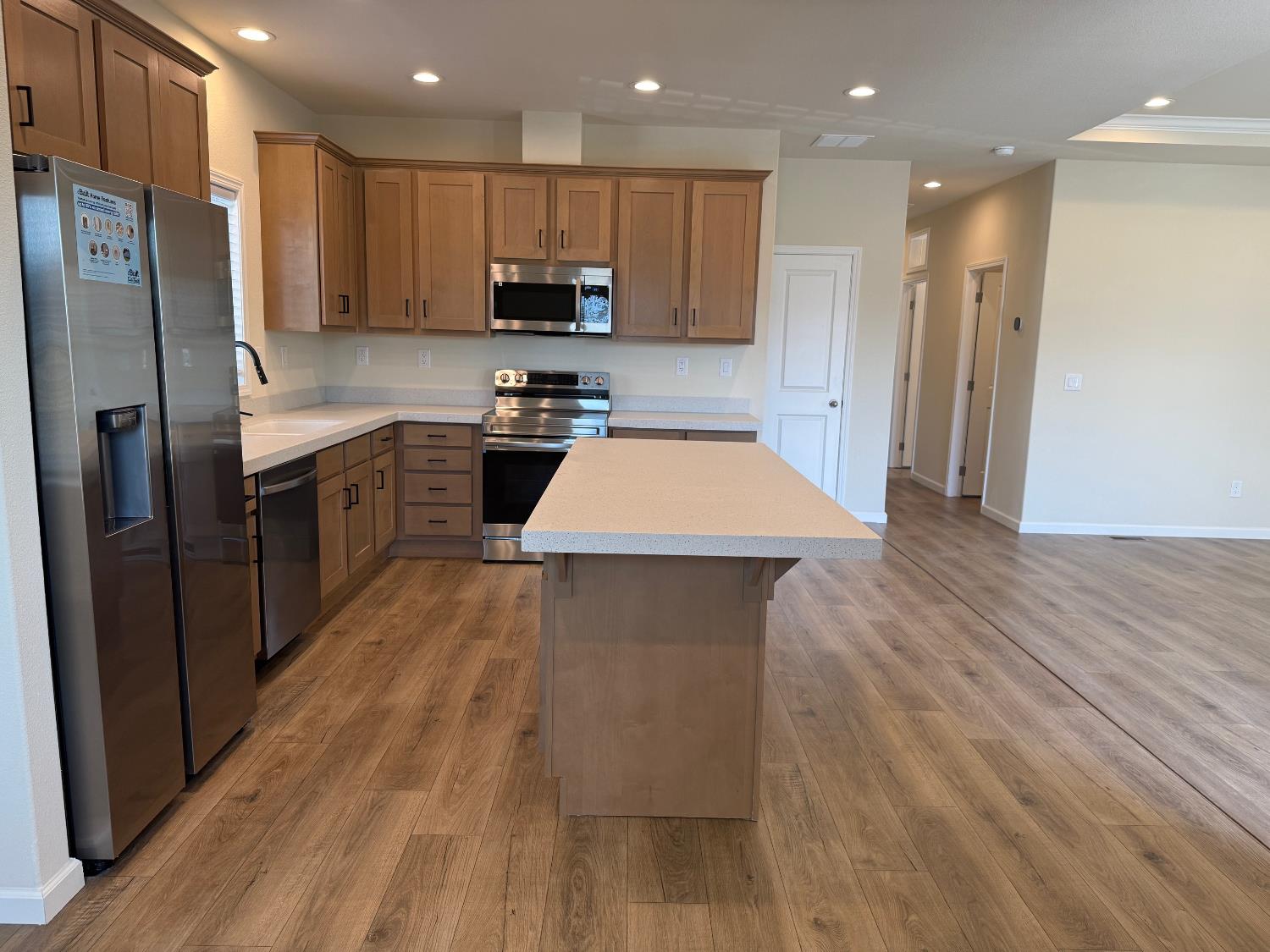 Undisclosed Address Medford, OR 97501 - Photo 8 of 23 a kitchen with stainless steel appliances kitchen island granite countertop wooden floor a stove a sink a refrigerator and cabinets