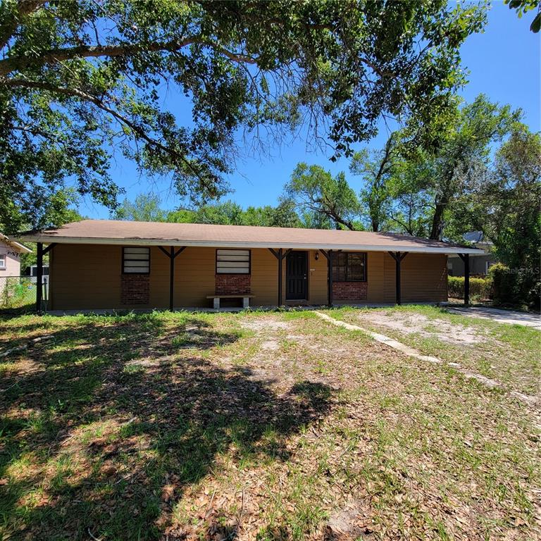 a front view of a house with a yard and a garage