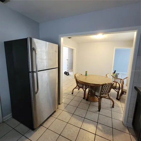 a kitchen with stainless steel appliances a refrigerator and a table