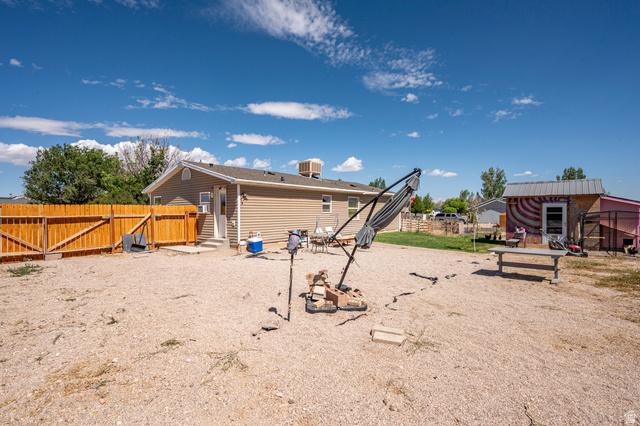 4296 Maple Lane Cedar City, UT 84721 - Photo 28 of 44 Expansive rear yard featuring a gravel surface, a wooden privacy fence, and a dedicated concrete patio area