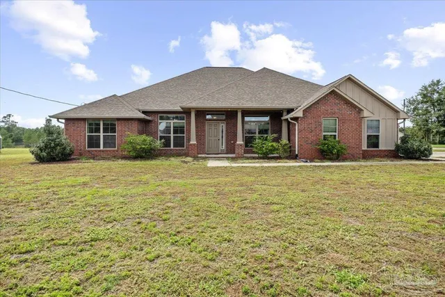 a front view of house with yard and green space