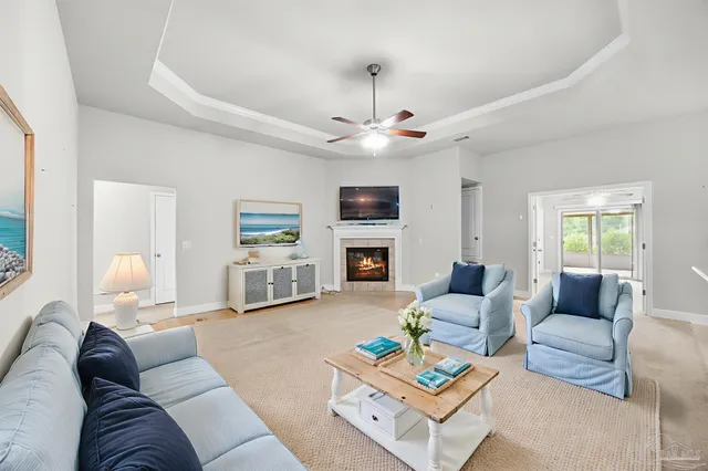 a living room with furniture a fireplace and a flat screen tv