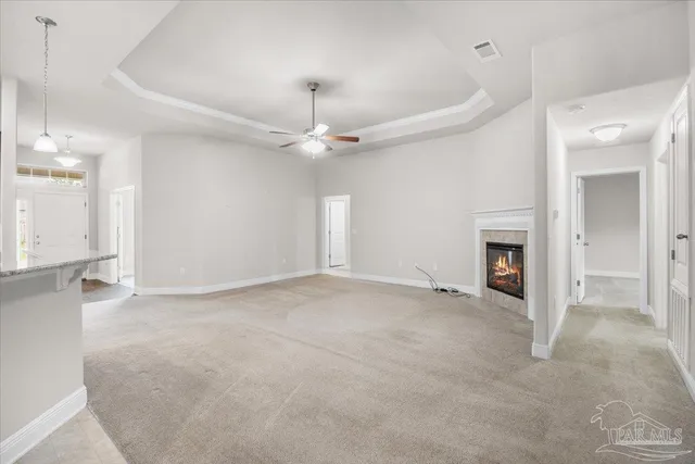 an empty room with a fireplace and fan