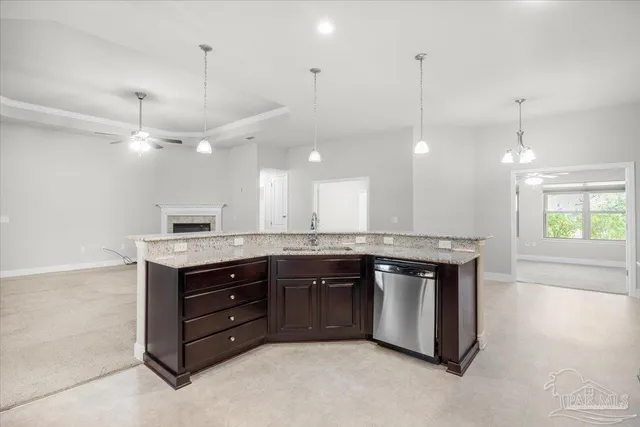 a kitchen with a stove kitchen island a sink and a stove