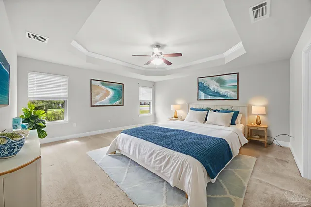 a bedroom with a large bed and a chandelier