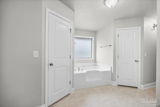 a bathroom with a granite countertop sink a toilet and a mirror