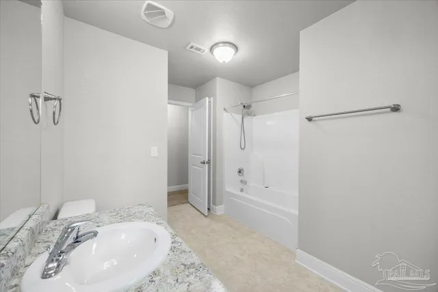 a bedroom with a large bed and a couch