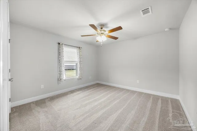 a bedroom with bed and a large window