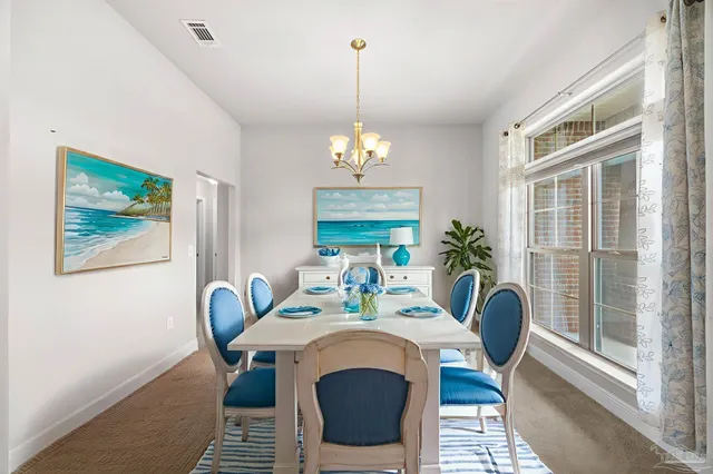 a view of a dining room with furniture wooden floor and chandelier