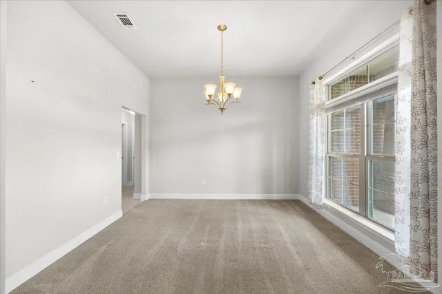 a view of a chandelier in big room and chandelier fan