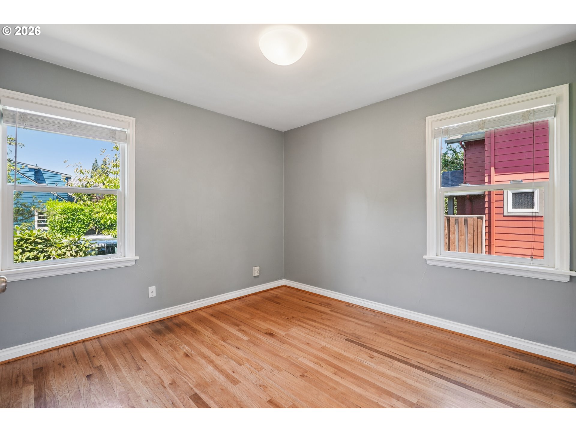 6406 Southeast 45th Avenue Portland, OR 97206 - Photo 14 of 39 an empty room with wooden floor and windows