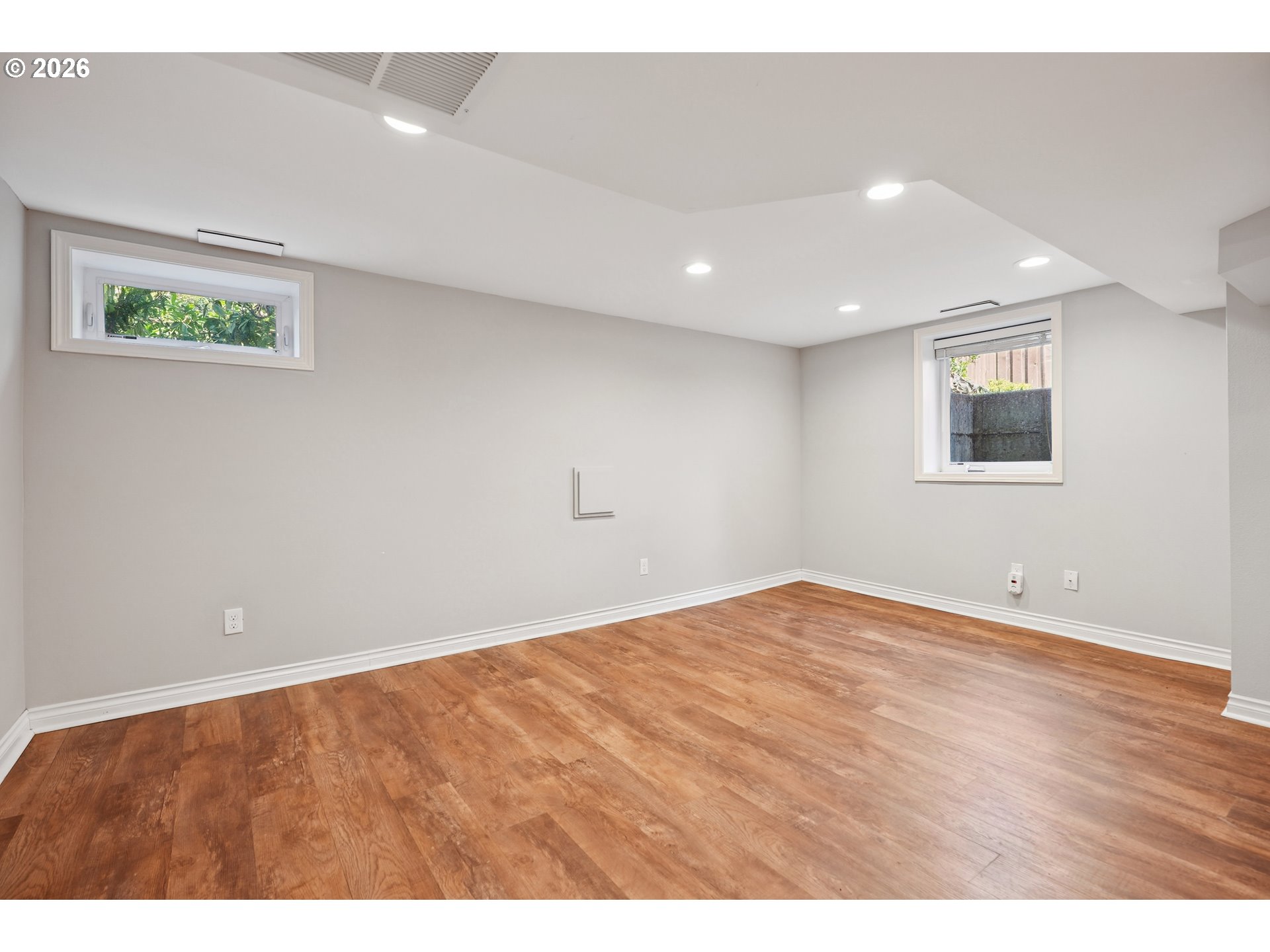6406 Southeast 45th Avenue Portland, OR 97206 - Photo 19 of 39 a view of an empty room with wooden floor and window
