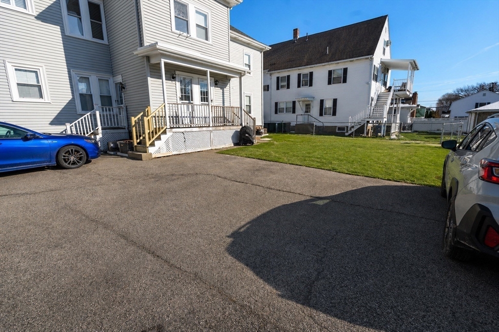 215 Ash Street, Unit 3 Waltham, MA 02453 - Photo 17 of 18 a car parked in front of a house