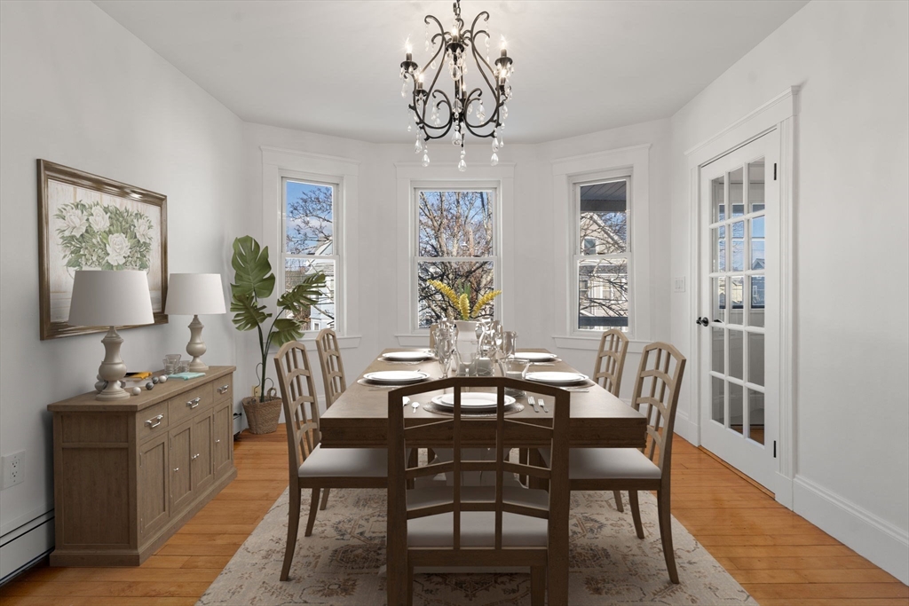 215 Ash Street, Unit 3 Waltham, MA 02453 - Photo 2 of 18 a view of a dining room with furniture window and wooden floor