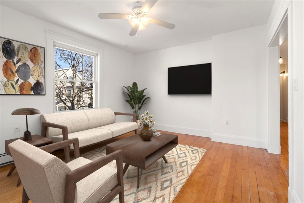 215 Ash Street, Unit 3 Waltham, MA 02453 - Photo 3 of 18 a living room with furniture and a flat screen tv
